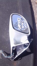 Left side exterior mirror for Opel Corsa, angled view, used condition.Left side exterior mirror for Opel Corsa