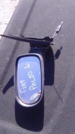 Left side mirror for a 2003 Fiat Palio, shown from the front angle, used condition.Left side mirror for a 2003