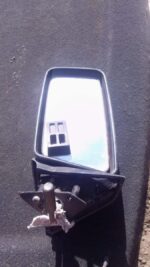 Used right side exterior mirror for Nissan Skyline shown from front angle with housing and glass visible.Used
