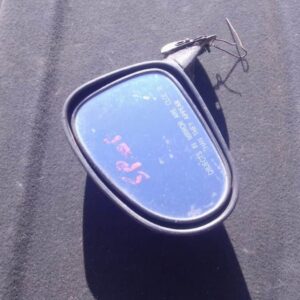 Left side mirror for Chevrolet Spark viewed from outside, used condition with visible mounting points.Left sid