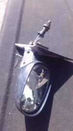 Right side car door mirror assembly shown from front angle, used condition visible on reflective surface.Right