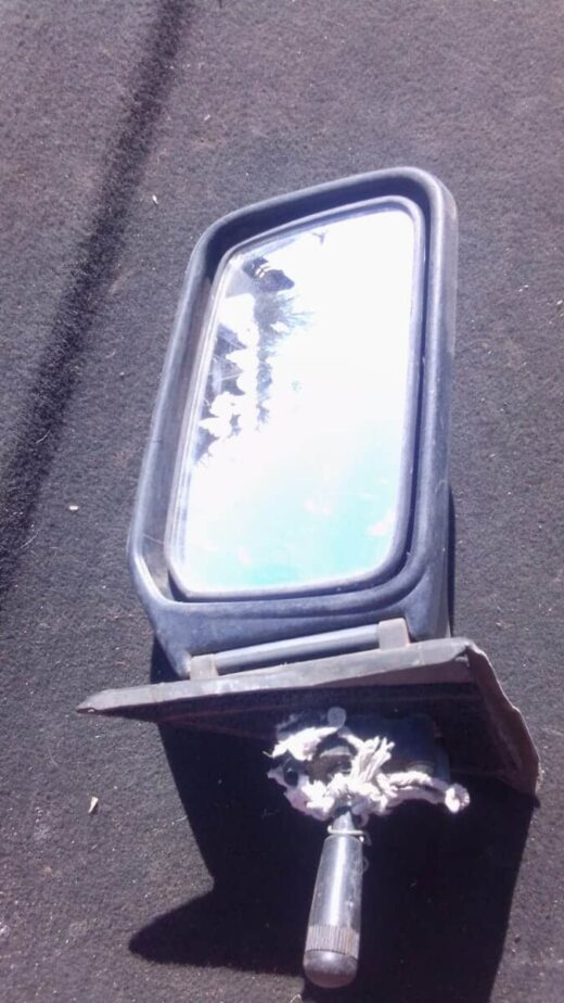 Honda Ballade Right Mirror - Used Right side car mirror for Honda Ballade, used condition, angled to show reflective glass and housing details.R