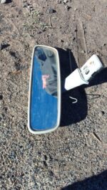 Rear view mirror for Toyota Runx shown from front angle, used condition.Rear view mirror for Toyota Runx shown
