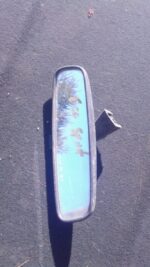 Rear view mirror for Ford Ecosport shown from the front, used condition visible on surface.Rear view mirror fo