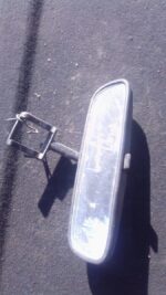 Used rearview mirror shown from front angle, ready for Toyota Corolla fitment, slight wear visible.Used rearvi