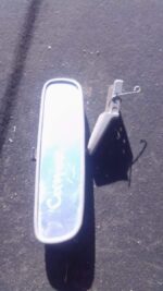 Used rear view mirror for Toyota Conquest shown front-facing against a plain background.Used rear view mirror