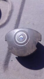 Front view of a used Renault Clio 3 steering wheel airbag module with central airbag cover.Front view of a use