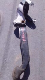 Close-up of a used brake pedal assembly from a Mercedes W204, viewed angled from the side against a white back
