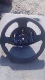 Used Renault Megane steering wheel shown from front with central horn pad and control buttons visible.Used Ren