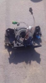 Front view of a used Renault Megane slip ring showing connectors and wiring terminals.Front view of a used Ren