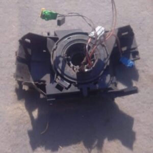 Front view of a used Renault Megane slip ring showing connectors and wiring terminals.Front view of a used Ren