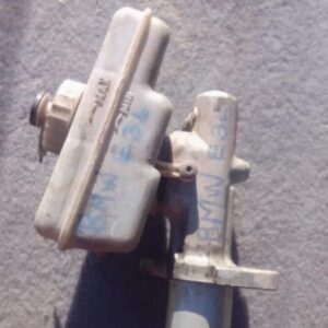 Used brake master cylinder for BMW E36, shown from front angle with mounting points and reservoir visible.Used
