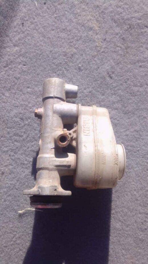 2004 Toyota Corolla Brake Master Cylinder - Used Used brake master cylinder angled front-left showing metal body and hydraulic ports for Corolla.Used brake mas
