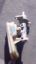 Front angled view of a used Peugeot 207 brake master cylinder showing mounting points and reservoir connection