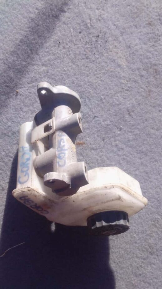 2007 Opel Corsa Brake Master Cylinder - Used Used brake master cylinder for Opel Corsa, angled side view showing key mounting points and cylinder body.Used