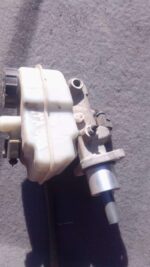 Used brake master cylinder angled front-left showing reservoir cap and mounting points for Volkswagen Polo Viv