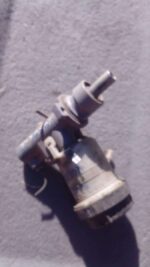 Front-facing view of a used brake master cylinder assembly for a Volvo S40, showing reservoir and metal housin