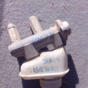 Front-angle view of a used brake master cylinder for Honda Civic, showing reservoir and mounting points.Front-