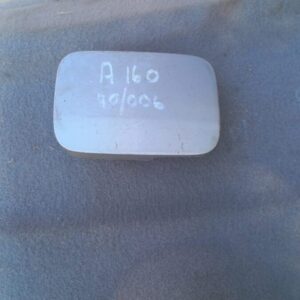 Used fuel flap for Mercedes A160 W168 shown from front angle against white background.Used fuel flap for Merce