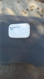 Used fuel flap for Mercedes W202 shown from a front angle on a plain background.Used fuel flap for Mercedes W2