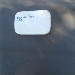 Used fuel flap for Mercedes W202 shown from a front angle on a plain background.Used fuel flap for Mercedes W2