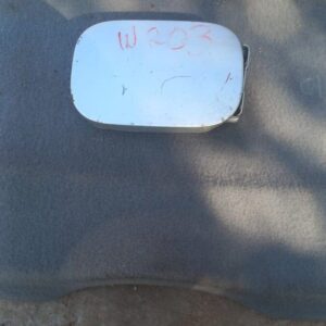 Used fuel flap for Mercedes W203 shown from a slight top angle highlighting its curved surface and hinge.Used