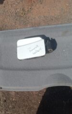 Used fuel flap for Volkswagen Amarok viewed from front, showing hinge and latch area.Used fuel flap for Volksw
