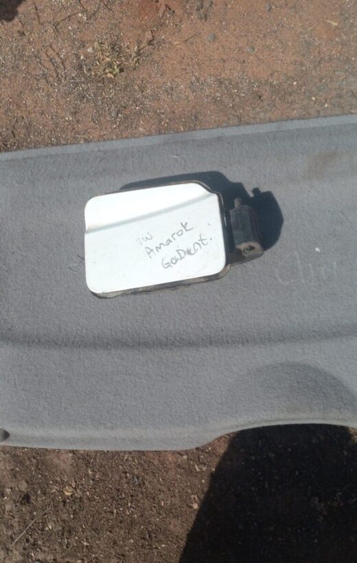 2010 Volkswagen Amarok Fuel Flap - Used Used fuel flap for Volkswagen Amarok viewed from front, showing hinge and latch area.Used fuel flap for Volksw