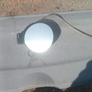 Used fuel flap for Volkswagen Golf 5 shown from front angle, clean and intact surface.Used fuel flap for Volks