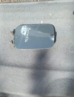 Used BMW E36 fuel flap shown front-facing with clear surface and minor wear marks visible.Used BMW E36 fuel fl