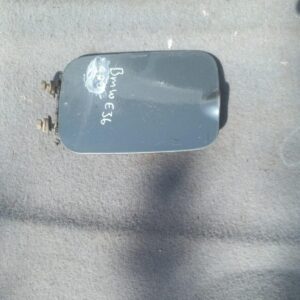 Used BMW E36 fuel flap shown front-facing with clear surface and minor wear marks visible.Used BMW E36 fuel fl