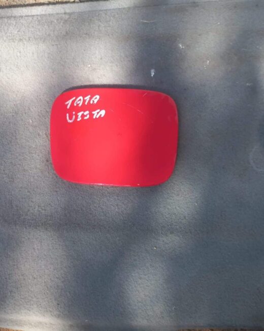 2007 Tata Indica Vista Fuel Flap - Used Used fuel flap for Tata Indica Vista, shown from front angle, with hinge and locking mechanism visible.Used fu