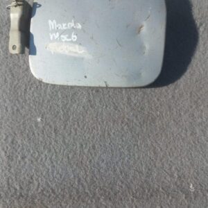 Used Mazda MX6 fuel flap shown from front-on angle with visible hinge and locking mechanism.Used Mazda MX6 fue