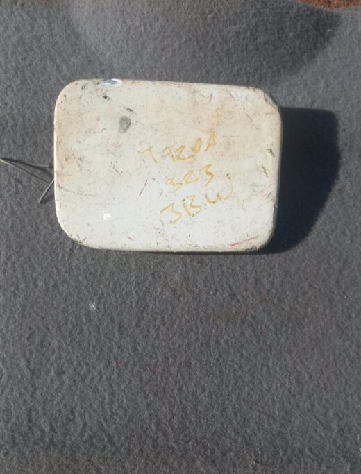 Mazda 323 Fuel Flap - Used Used Mazda 323 fuel flap shown front-facing on a neutral background, suitable for replacement.Used Mazda 323 f