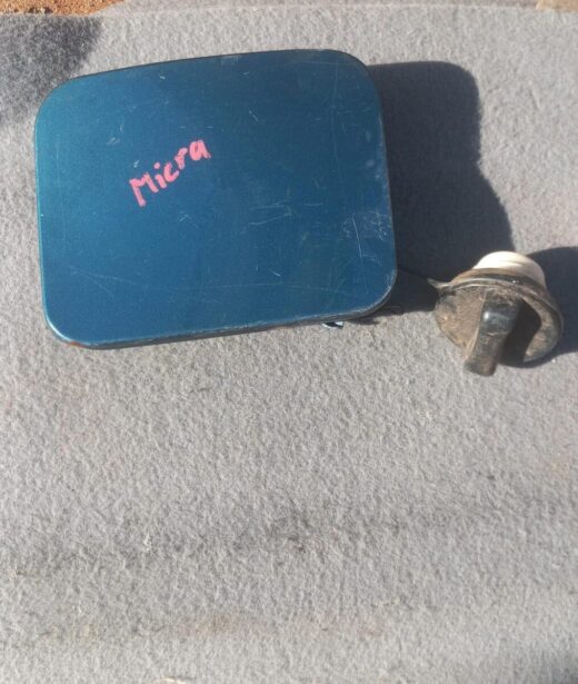 2016 Nissan Micra Fuel Flap - Used Used fuel flap for Nissan Micra, shown front-facing on a clean white background.Used fuel flap for Nissan Micr