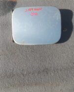 Used fuel flaps for a 2012 Datsun Go shown from a front angle on a plain background.Used fuel flaps for a 2012