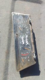 Front view of a used Nissan Sentra dashboard instrument cluster showing speedometer and gauges.Front view of a