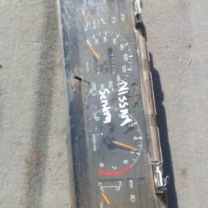 Front view of a used Nissan Sentra dashboard instrument cluster showing speedometer and gauges.Front view of a