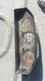 Front view of a used Mercedes W124 instrument cluster with clear gauges and indicator lights.Front view of a u