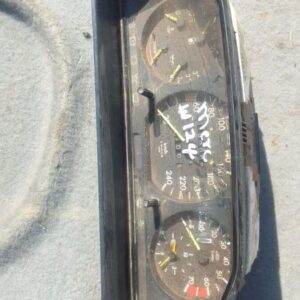 Front view of a used Mercedes W124 instrument cluster with clear gauges and indicator lights.Front view of a u