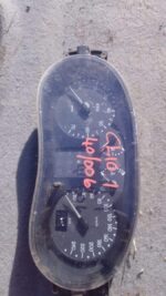 Close-up of a used Renault Clio 1 dashboard cluster showing speedometer and gauges from the front angle.Close-
