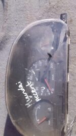 Front view of used Hyundai Accent dashboard instrument cluster with gauges and display panel.Front view of use