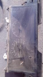 Front view of a used Toyota Cressida dashboard cluster with gauges and indicator lights visible.Front view of