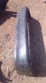 Rear bumper for Toyota Tazz, viewed from rear angle, used condition with mounting points visible.Rear bumper f