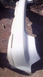 Used rear bumper for Mazda 6 shown from the back at an angle, displaying wear and mounting points.Used rear bu
