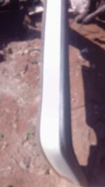 Rear view of a used Nissan Sentra rear bumper showing mounting points and black plastic lower trim.Rear view o