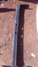Front view of a used Nissan Skyline front bumper displayed against a plain background.Front view of a used Nis