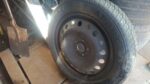 Front view of a used spare wheel rim for a 2013 Ford Kuga showing five-spoke design and mounting holes.Front v