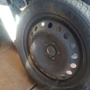 Front view of a used spare wheel rim for a 2013 Ford Kuga showing five-spoke design and mounting holes.Front v