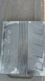 Used engine cover from a Dodge Nitro, shown front-facing on a white background.Used engine cover from a Dodge